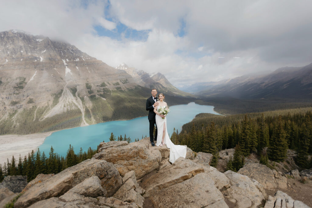Bride & Groom Standing at a viewpoint at Peyto Lake in Banff, Canada