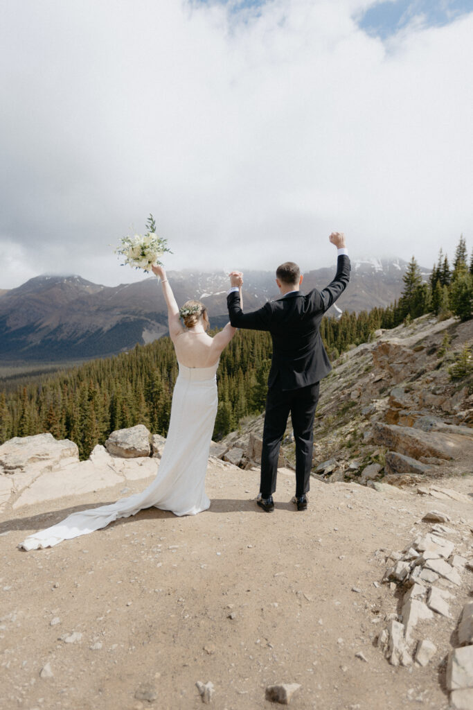Couple cheering at peyto lake, banff, canada
